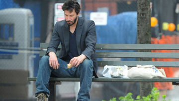 Classic Sad Keanu Reeves sitting on a bench photograph